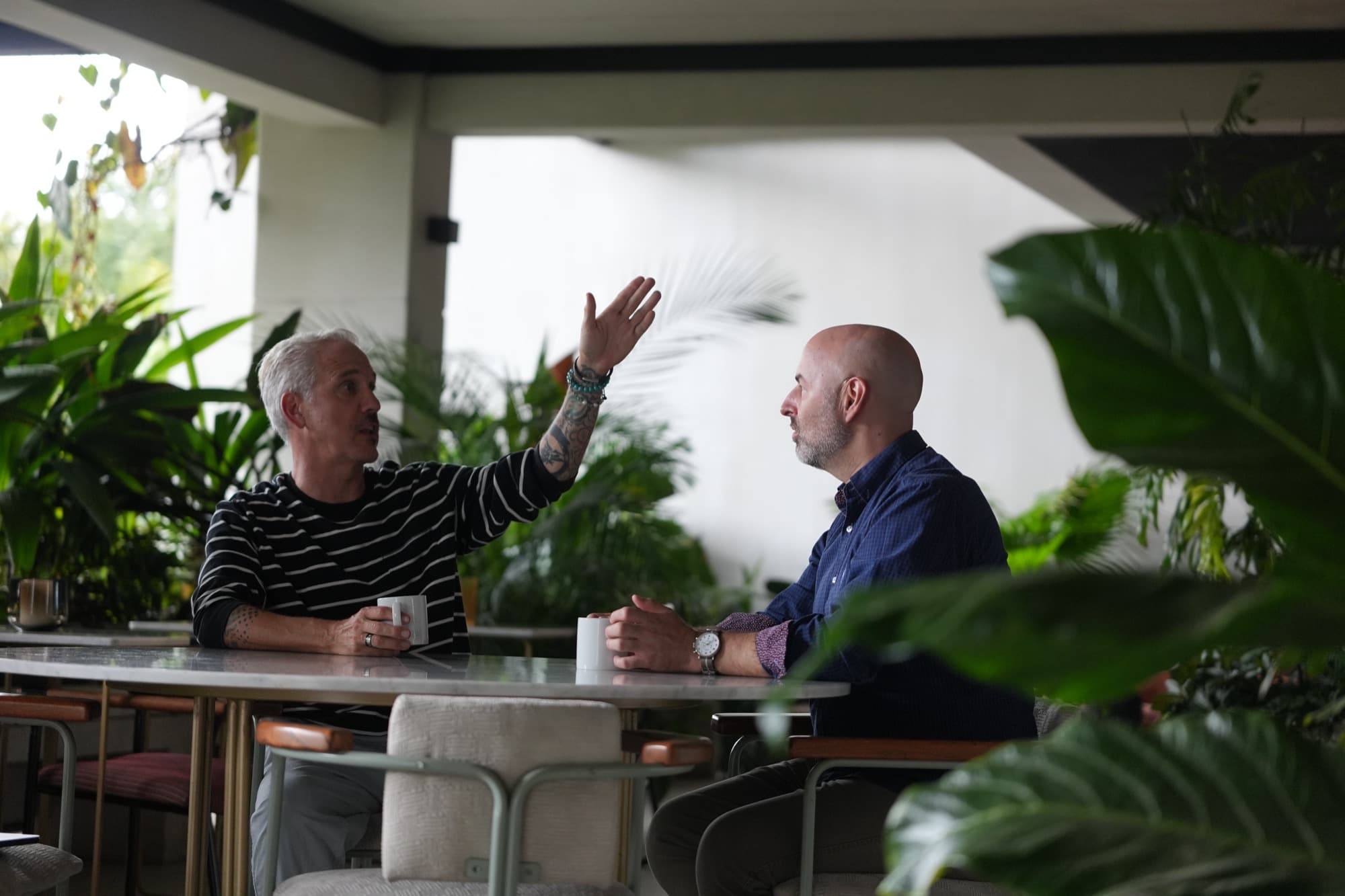 Patrick Jager and Aaron Bailey talking over coffee in Costa Rica